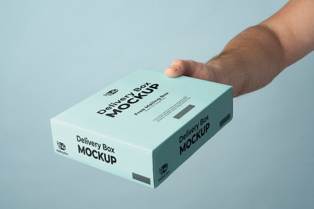 Hand holding blue delivery pack mockup