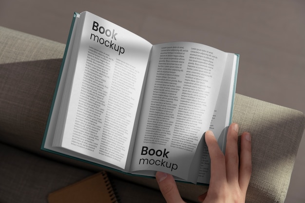 Hand holding book mock-up