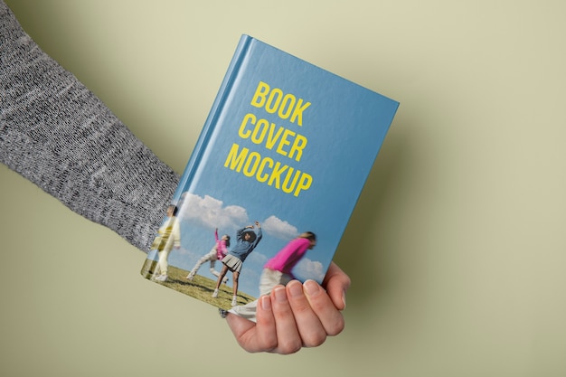 Hand holding  book mockup