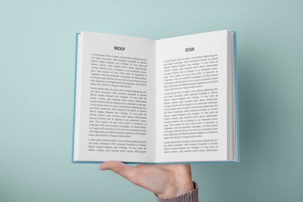 Hand holding  book mockup