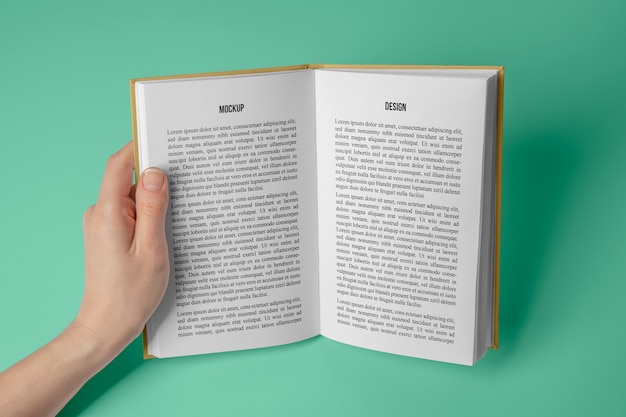 Hand holding  book mockup