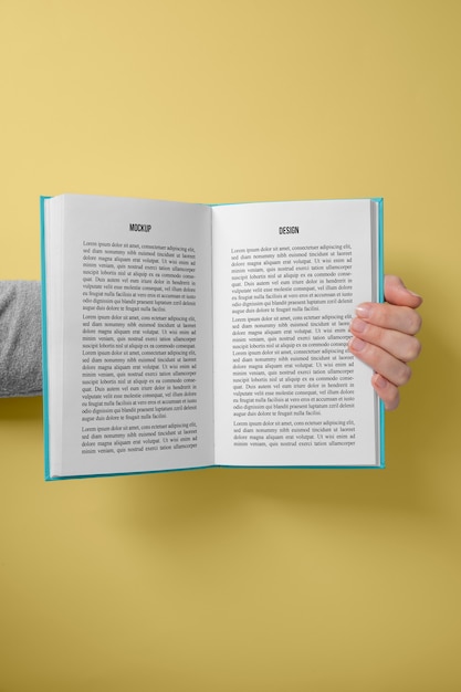 Hand holding  book mockup