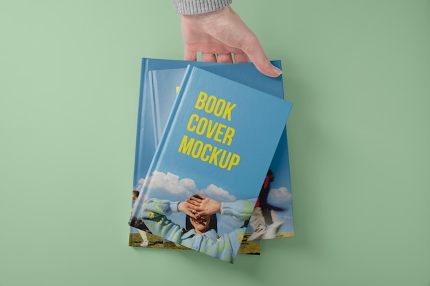 Hand holding  book mockup