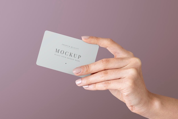 Hand holding a card psd mockup