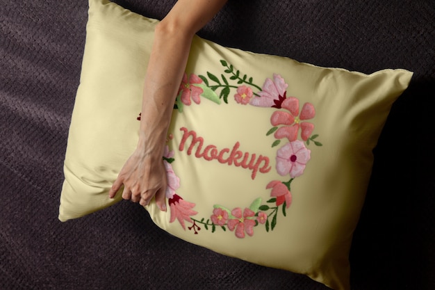 Hand holding floral cushion top view