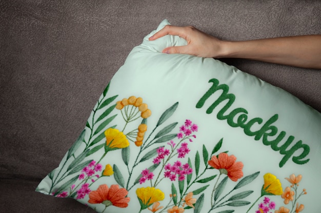 Hand holding floral cushion