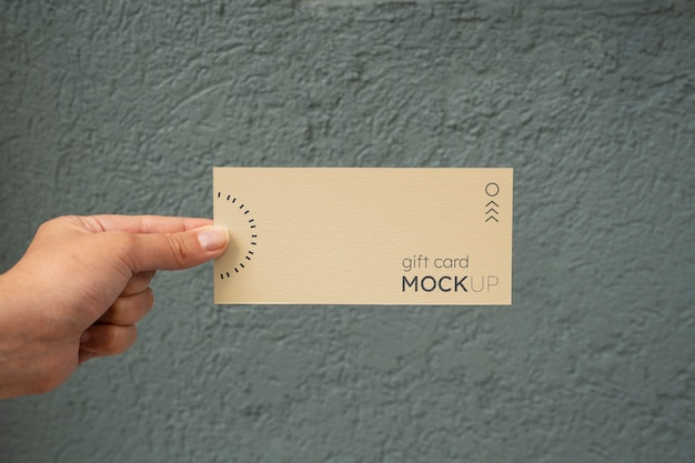 Hand holding gift card mockup