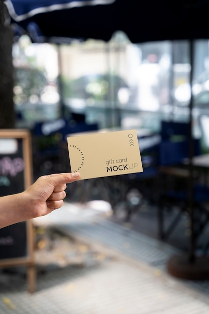 Hand holding gift card mockup