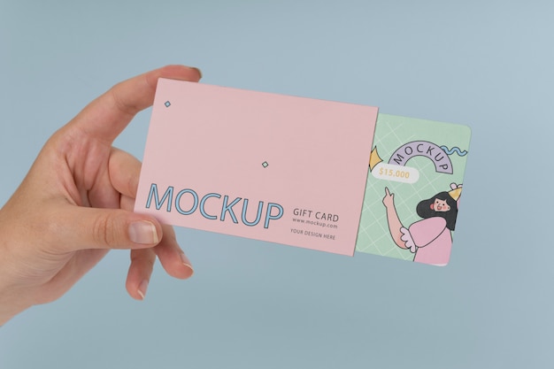 Hand holding gift card mockup