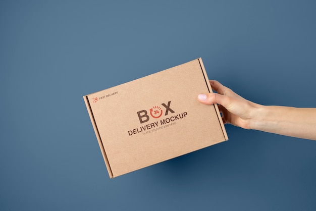 Hand holding mailing box mockup