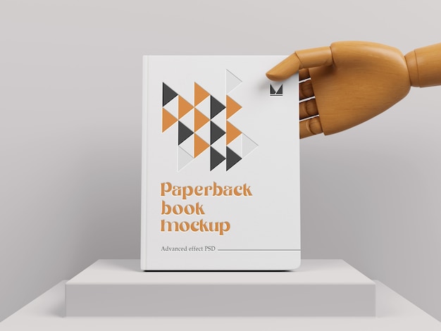 PSD hand holding paperback book mockup