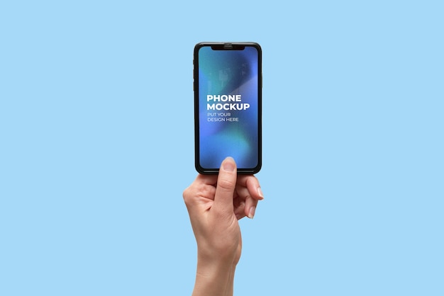 Hand holding smartphone device mock-up on color background