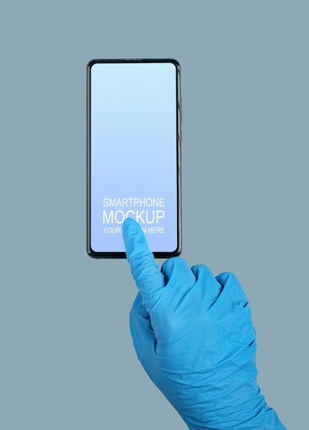 A hand holding a smartphone with a blue glove on it that says smartphone mockup.