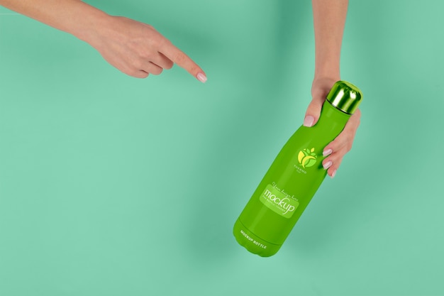 PSD hand holding thermos mockup