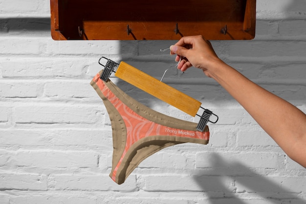 Hand holding thong mockup