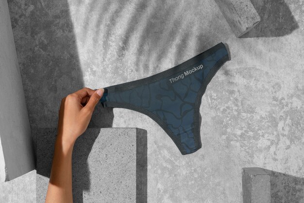 Hand holding thong mockup