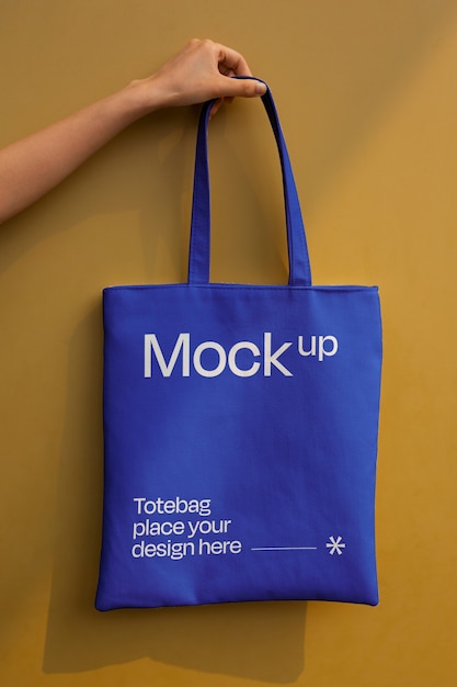 Hand holding totebag mockup