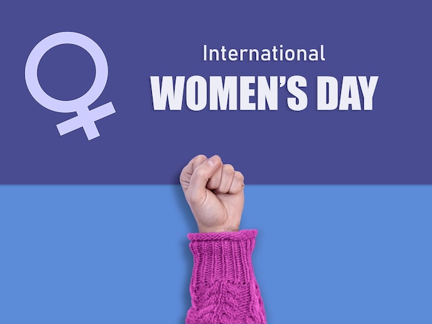 A hand with raised fist on a blue and purple background with text International Women's Day