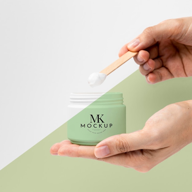 Hands holding beauty product mock-up