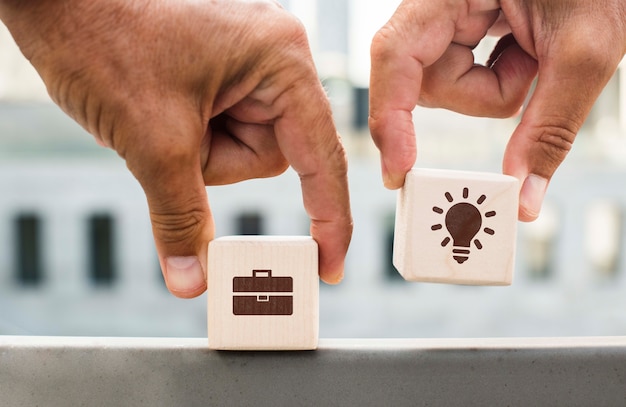 Hands holding dices with company ideas outdoors