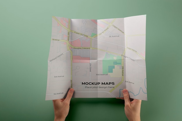 Hands holding map mockup flat lay