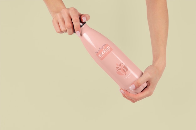 Hands holding thermos mockup