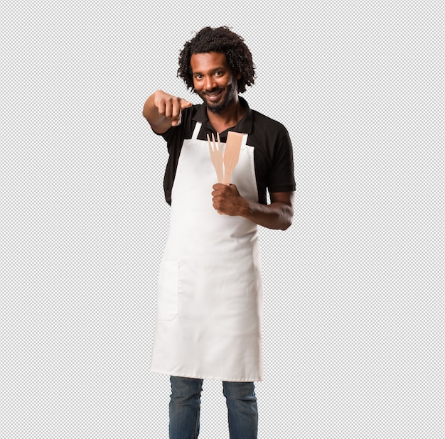 PSD handsome african american baker cheerful and smiling pointing to the front