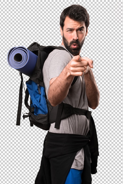 Handsome backpacker pointing to the front