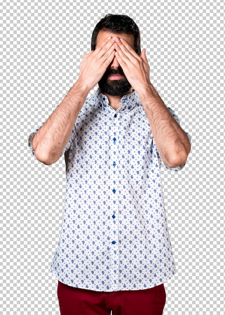 Handsome brunette man with beard covering his eyes