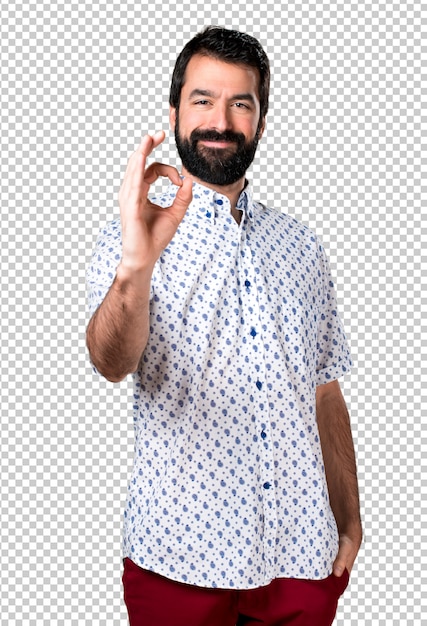 Handsome brunette man with beard making OK sign