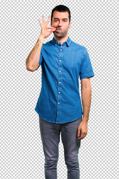 Handsome man with blue shirt showing a sign of closing mouth and silence gesture