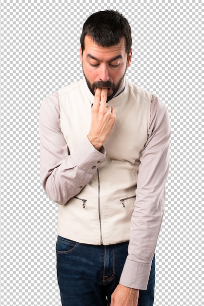 Handsome man with vest making vomiting gesture