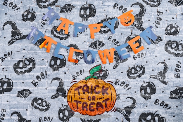 Happy halloween garland and pumpkin with trick or treat lettering