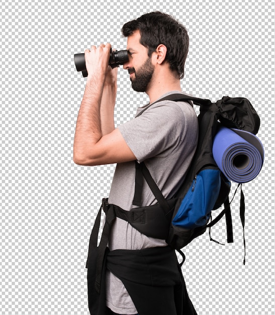 Happy Handsome backpacker with binoculars