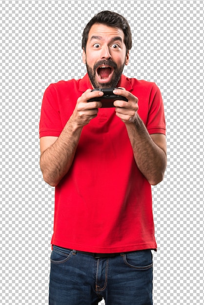 Happy handsome young man playing videogames