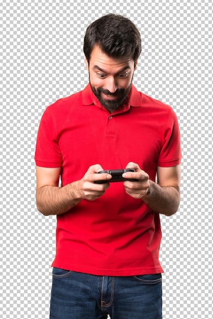 Happy handsome young man playing videogames