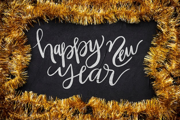 PSD happy new year handwriting lettering surrounded my tinsel