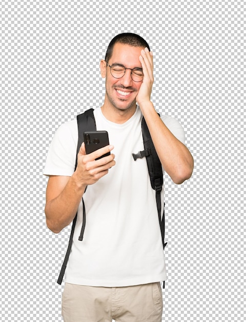 Happy student using his mobile phone