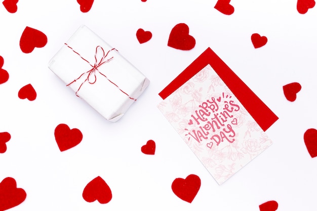 Happy valentines day card next to wrapped gift