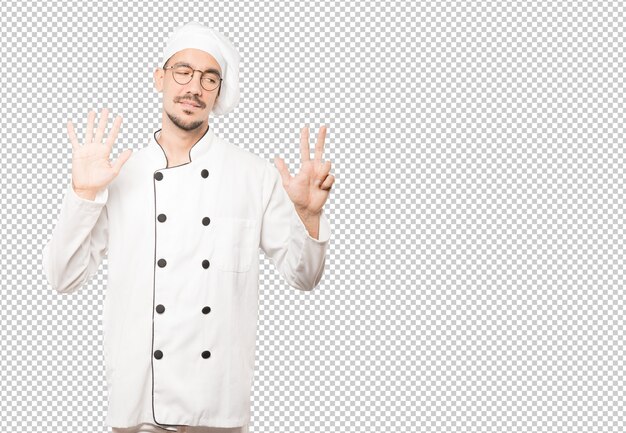 PSD happy young chef doing a number eight gesture with his hands