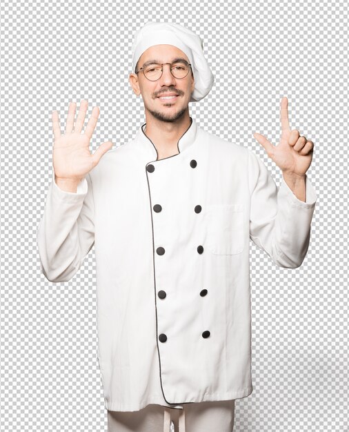 PSD happy young chef doing a number seven gesture with his hands