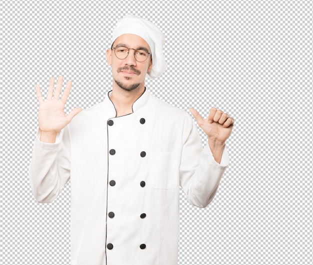 PSD happy young chef doing a number six gesture with his hands