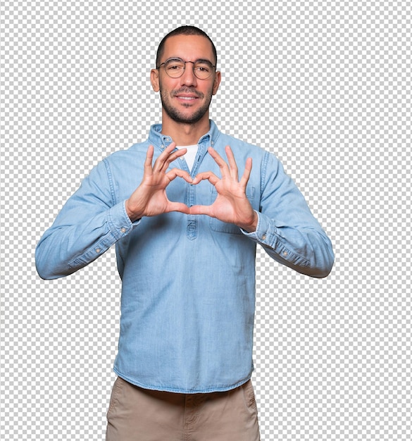 Happy young man doing a gesture of love with his hands