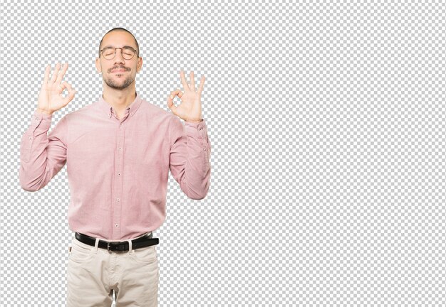 Happy young man doing a gesture of meditation