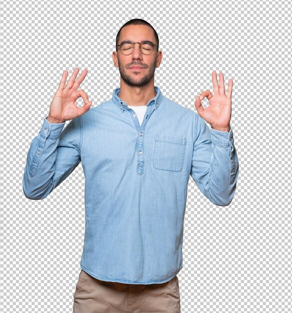 Happy young man doing a gesture of meditation