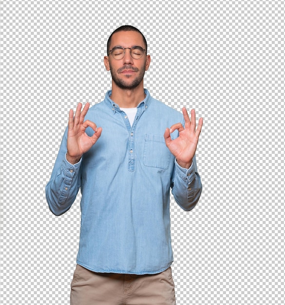 Happy young man doing a gesture of meditation