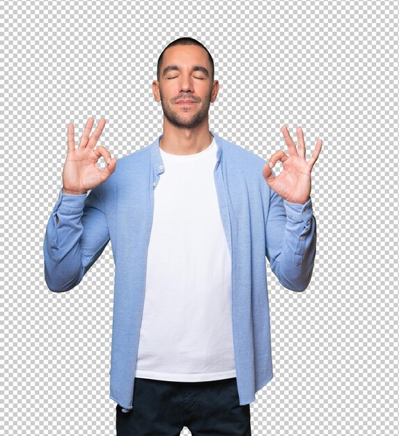 Happy young man doing a gesture of meditation