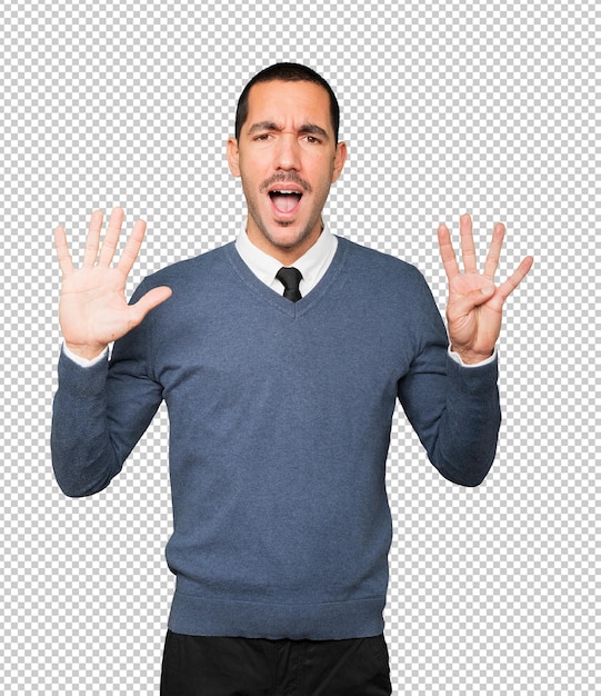 Happy young man doing a number nine gesture with his hands