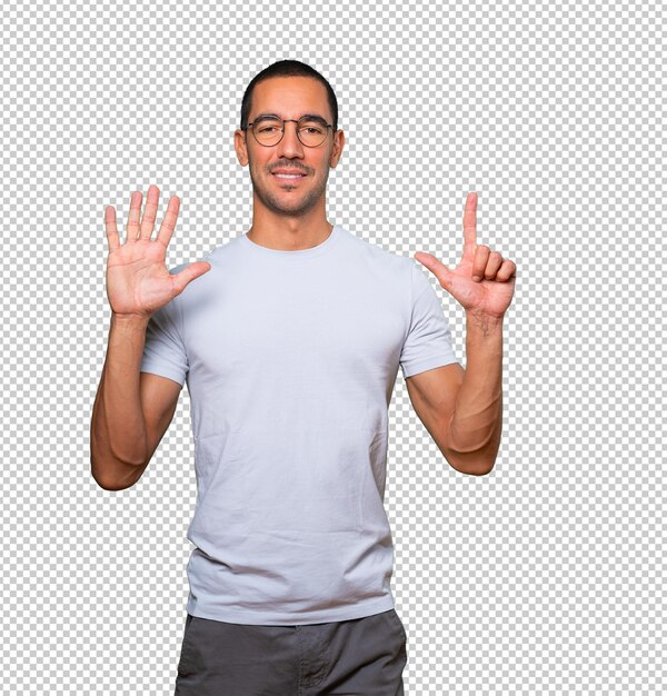 Happy young man doing a number seven gesture with his hands