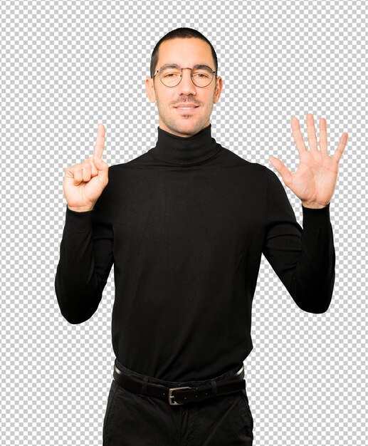 Happy young man doing a number six gesture with his hands